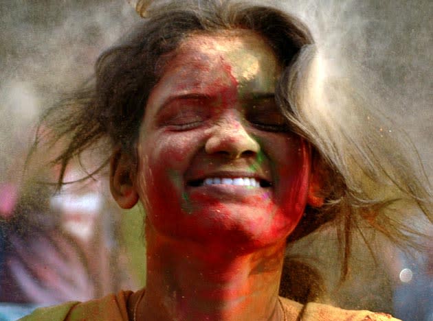 An Indian girl reacts as others throw color powder at her as part of celebrating "Holi" in the outskirts of Bhubaneswar, India, Saturday, Feb .27, 2010. The festival also marks the coming of spring. (AP Photo/Biswaranjan Rout)