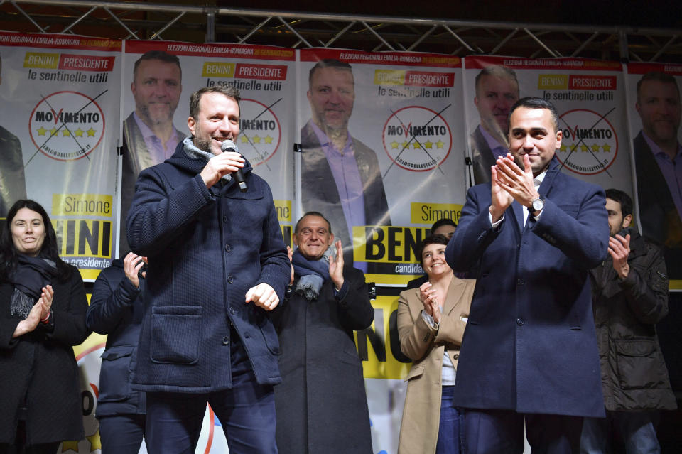 Simone Benini, left, of the Five Star Movement of Emilia-Romagna speaks during a campaign event as Italian Foreign Minister Luigi Di Maio applauds at right, in Bologna, Italy, on Thursday, Jan. 23, 2020. (Massimo Paolone/LaPresse via AP)