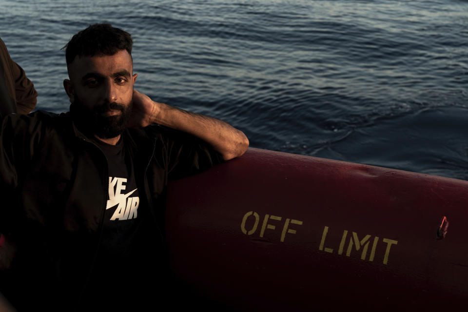 A migrant rescued in the Mediterranean Sea stands onboard of the Ocean Viking rescue ship, Tuesday, Nov. 1, 2022. (AP Photo/Vincenzo Circosta)