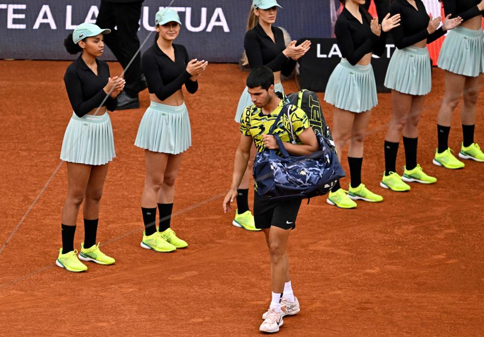 Carlos Alcaraz (pictured) walks out in front of the female ball women on the Caja Magica. (Photo by JAVIER SORIANO/AFP via Getty Images)