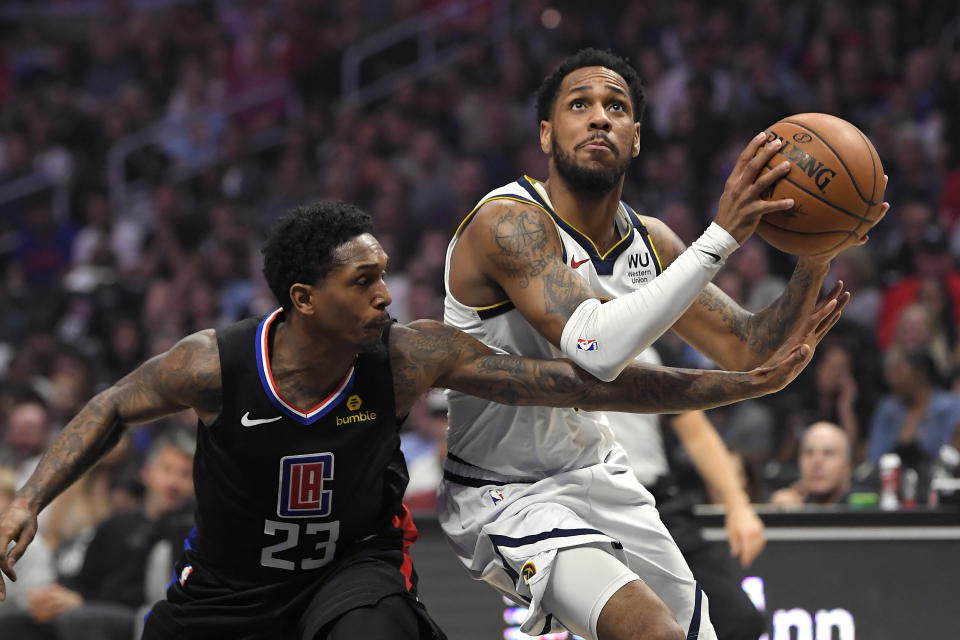 Denver Nuggets guard Monte Morris, right, moves to the basket as Los Angeles Clippers guard Lou Williams defends during the first half of an NBA basketball game Friday, Feb. 28, 2020, in Los Angeles. (AP Photo/Mark J. Terrill)
