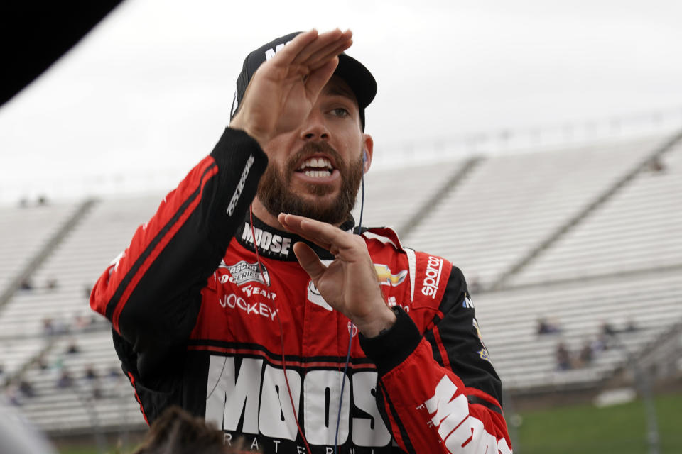 Ross Chastain gestures as he talks to a crew member during practice for the NASCAR auto race at Martinsville Speedway, Saturday, Oct. 29, 2022, in Martinsville, Va. (AP Photo/Chuck Burton)