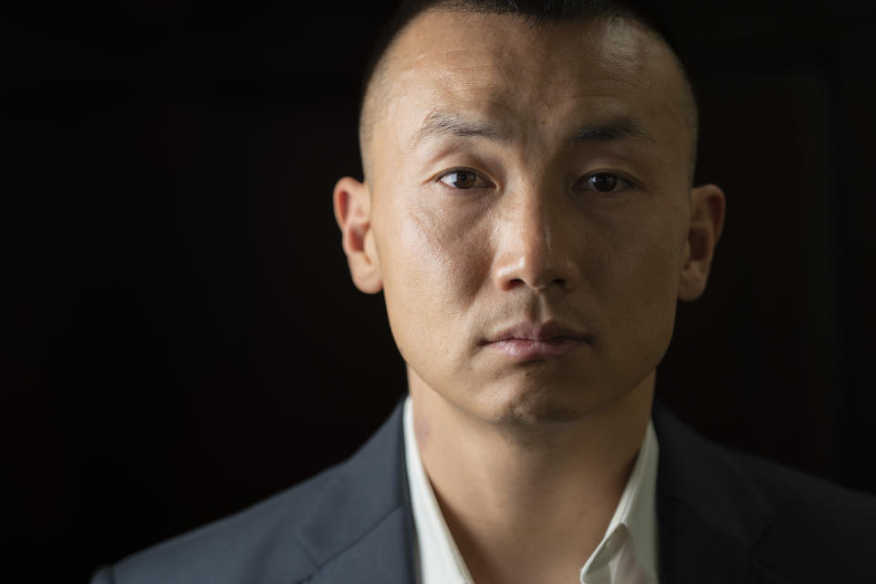Baimadajie Angwang is photographed at the Law Office of John F. Carman, Esq., after an interview with the Associated Press, Wednesday, Feb. 1, 2023, in Garden City, N.Y. In a few terrifying minutes nearly three years ago, Angwang's life took an abrupt turn — from a teenaged asylum seeker, U.S. Marine and NYPD officer to an accused spy for China. Last month the government dismissed charges against him without fully explaining why. (AP Photo/John Minchillo)
