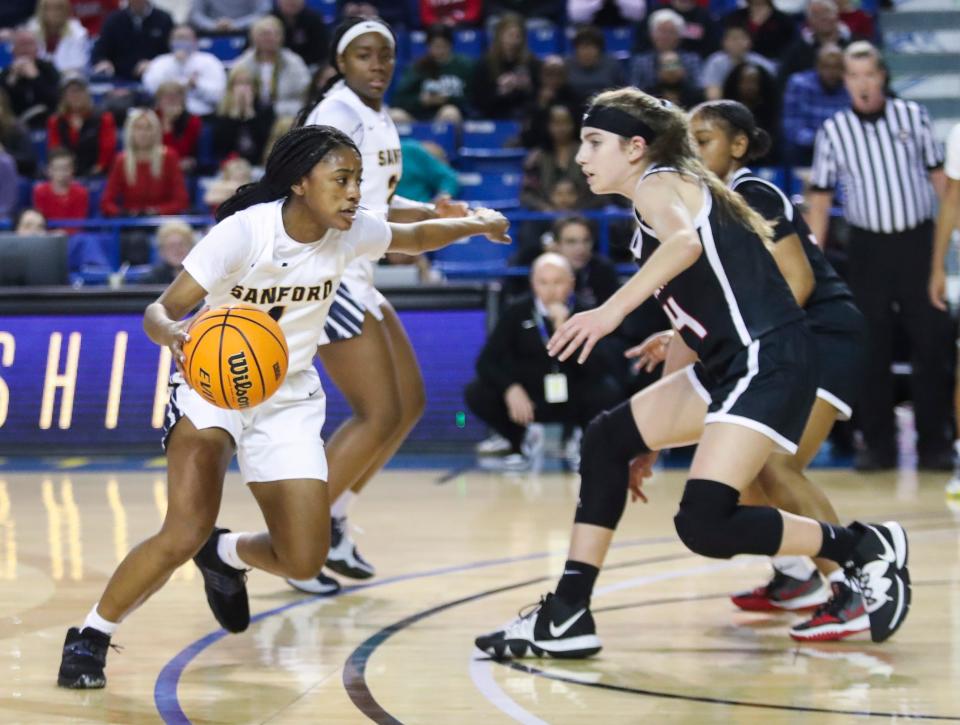 Sanford's Zy Kilgoe looks to drive against Ursuline's Abby Grillo in the first half of a DIAA state tournament semifinal at the Bob Carpenter Center Wednesday, March 9, 2022. The Warriors won, 43-26.