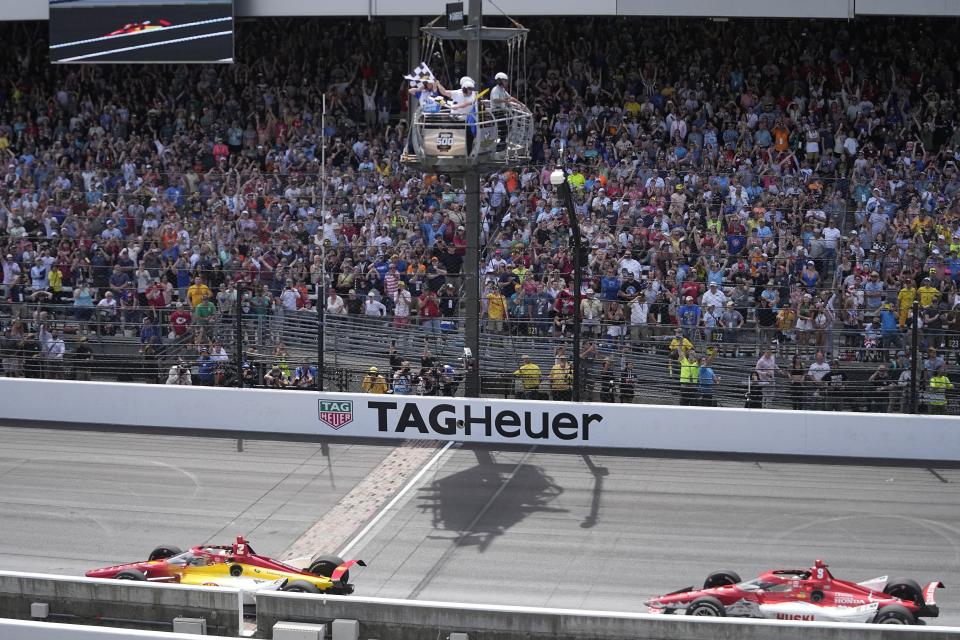Josef Newgarden takes the checkered flag ahead of Marcus Ericsson, of Sweden, to win the Indianapolis 500 auto race at Indianapolis Motor Speedway, Sunday, May 28, 2023, in Indianapolis. (AP Photo/Darron Cummings)
