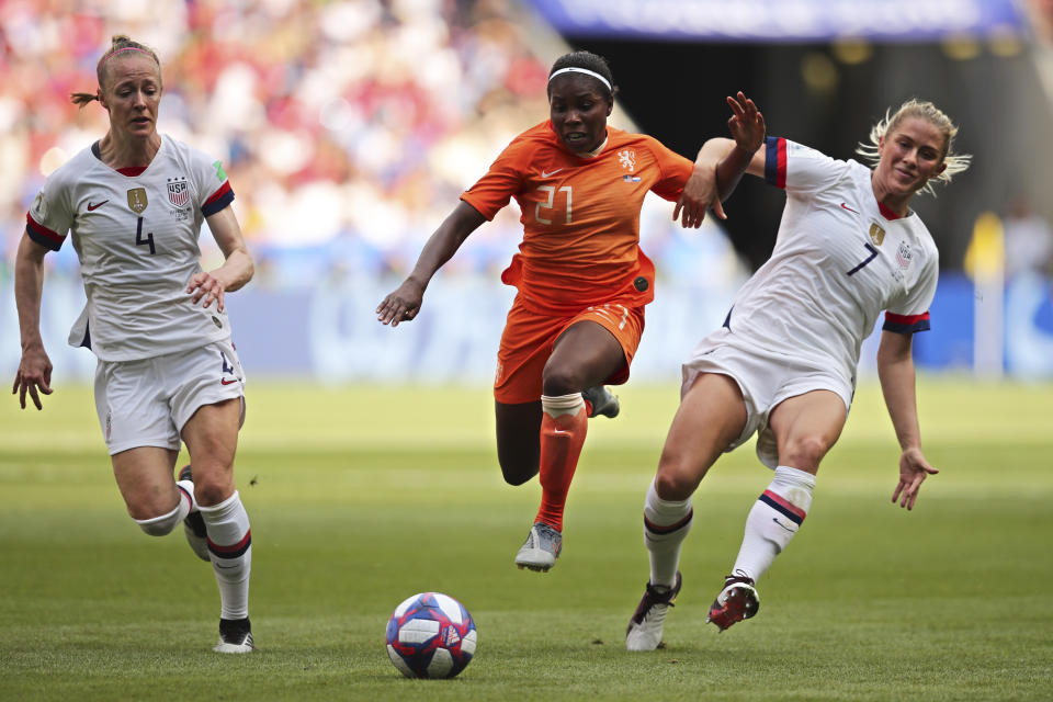 Netherlands' Lineth Beerensteyn is fouled by United States' Abby Dahlkemper, right, as United States' Becky Sauerbrunn, left, looks on during the Women's World Cup final soccer match between US and The Netherlands at the Stade de Lyon in Decines, outside Lyon, France, Sunday, July 7, 2019. (AP Photo/Francisco Seco)