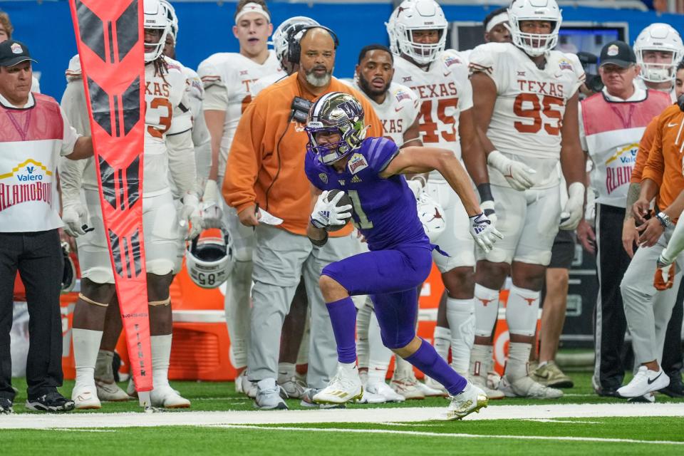 Dec 29, 2022; San Antonio, Texas, USA; Washington Huskies wide receiver Jalen McMillan (11) runs the ball in the 2022 Alamo Bowl against the Texas Longhorns at the Alamodome. Mandatory Credit: Daniel Dunn-USA TODAY Sports