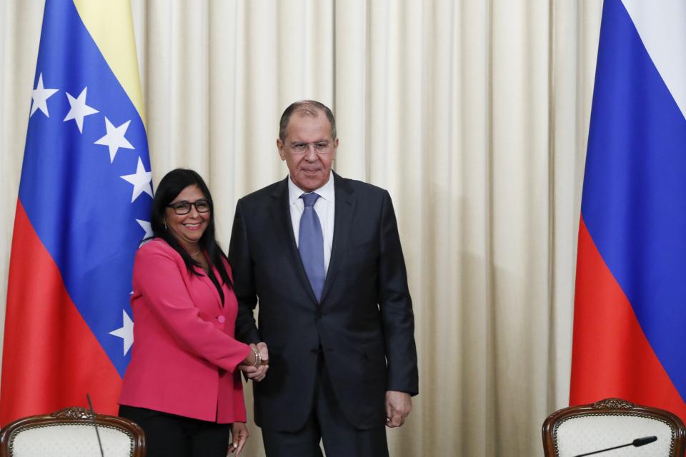 Russian Foreign Minister Sergey Lavrov, centre and Venezuela's Vice President Delcy Rodriguez shake hands after a joint news conference following their talks in Moscow, Russia, Friday, March 1, 2019. Venezuela’s vice president is visiting Russia, voicing hope for stronger ties with Moscow amid the U.S. pressure. (AP Photo/Pavel Golovkin)