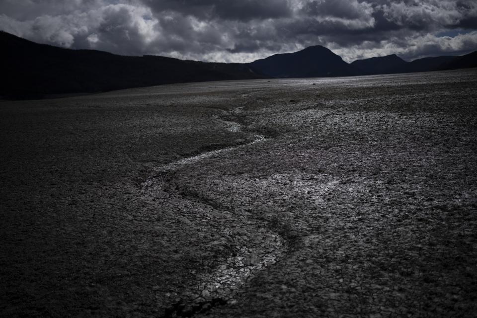 FILE - A usually submerged section of the lake Serre-Poncon is dry in southern France, March 14, 2023. A major new United Nations report being released Monday, March 20, 2023, is expected to provide a sobering reminder that time is running out if humanity wants to avoid passing a dangerous global warming threshold. (AP Photo/Daniel Cole, File)