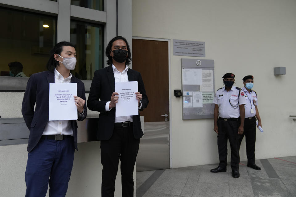 Activists pose with a memorandum before a candlelight vigil against the impending execution of Nagaenthran K. Dharmalingam, sentenced to death for trafficking heroin into Singapore, outside the Singaporean embassy in Kuala Lumpur, Malaysia, Monday, Nov. 8, 2021. Singapore's High Court has halted the imminent execution of a Malaysian man believed to have a mental disability, amid pleas from the international community and rights groups. (AP Photo/Vincent Thian)