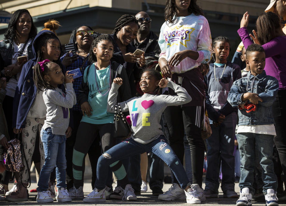 In this Monday, Jan. 15, 2018 photo, people line Texas Avenue to watch The "Original" MLK, Jr. Parade in Houston. For more than two decades, competing MLK Day parades have been held in Houston. This year, the city of Houston threw its official support behind one parade, the 41st annual “Original” MLK, Jr. Parade, hoping the city could unite behind only one parade. But organizers of the other parade, the 25th annual MLK Grande Parade, will still be holding its event and they say they have no plans to stop having their own parade. ( Brett Coomer/Houston Chronicle via AP)