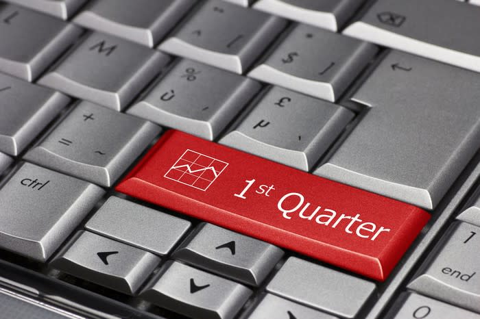 A silver keyboard with a red key showing the words 1st quarter.