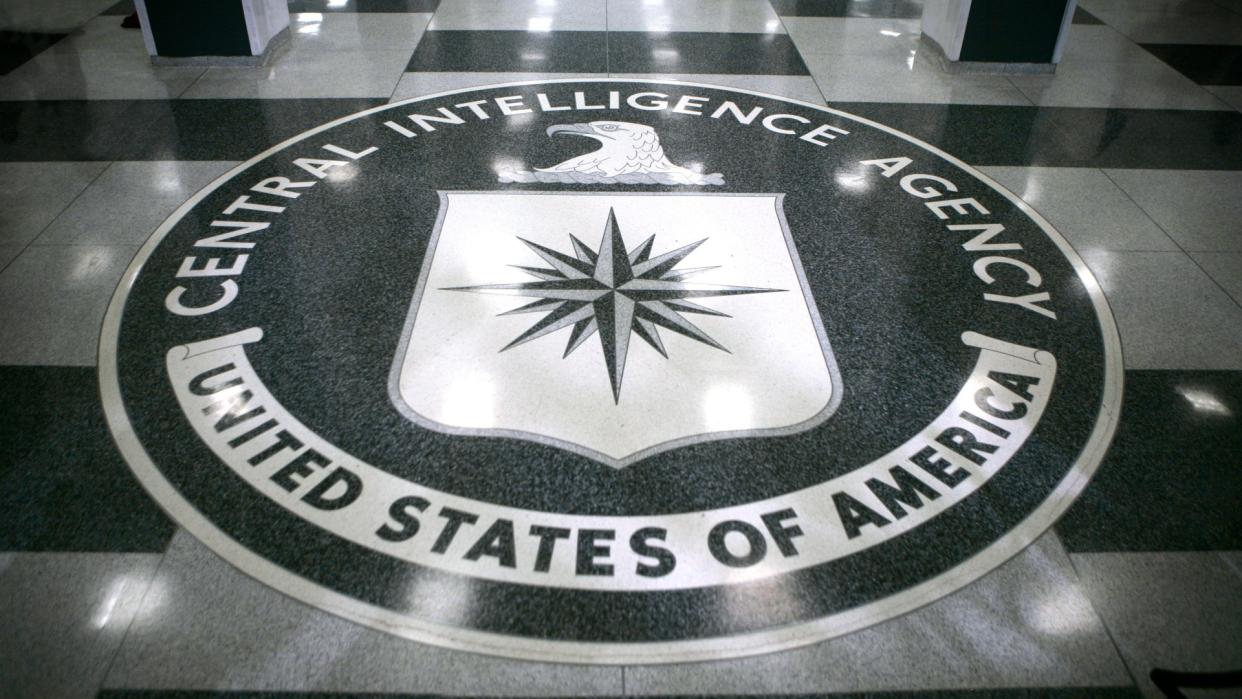  a seal on a marble floor that reads "Central Intelligence Agency" 