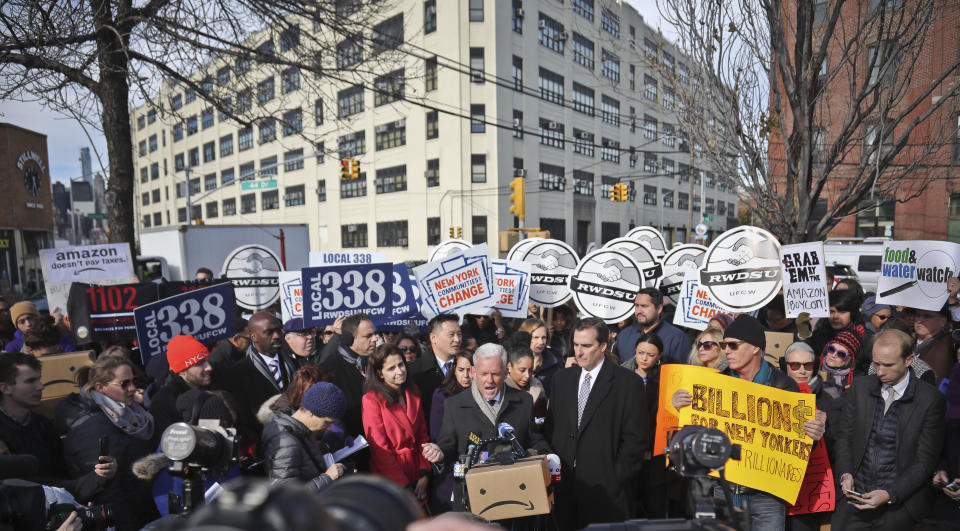 FILE - In this Nov. 14, 2018 file photo, New York City Councillor Jimmy Van Bramer, center, speaks during a coalition rally and press conference of elected officials, community organizations and unions opposing Amazon headquarters getting subsidies to locate in the New York neighborhood of Long Island City, Queens. Some people asked why Amazon, one of the world's most valuable companies, needed nearly $3 billion in tax incentives to come to New York. (AP Photo/Bebeto Matthews, File)