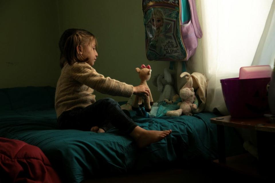 Roya Habibi plays with donated toys in her room (Reuters)