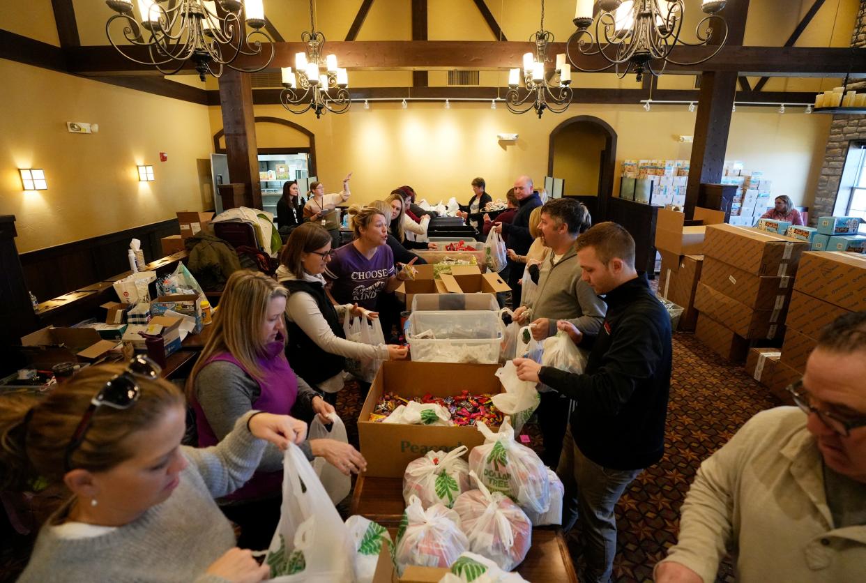 Volunteers pack "blessing bags" full of food Monday at the former Montgomery Inn in Dublin for Feed the Kids Columbus, which provides food bags over extended school breaks like Thanksgiving to some 6,000 kids in 25 schools in Columbus City Schools, Dublin Schools, Groveport-Madison School and South-Western City Schools. The group's founder, Ashley Kanney, started donating the bags in 2019 to help feed kids over the holidays.