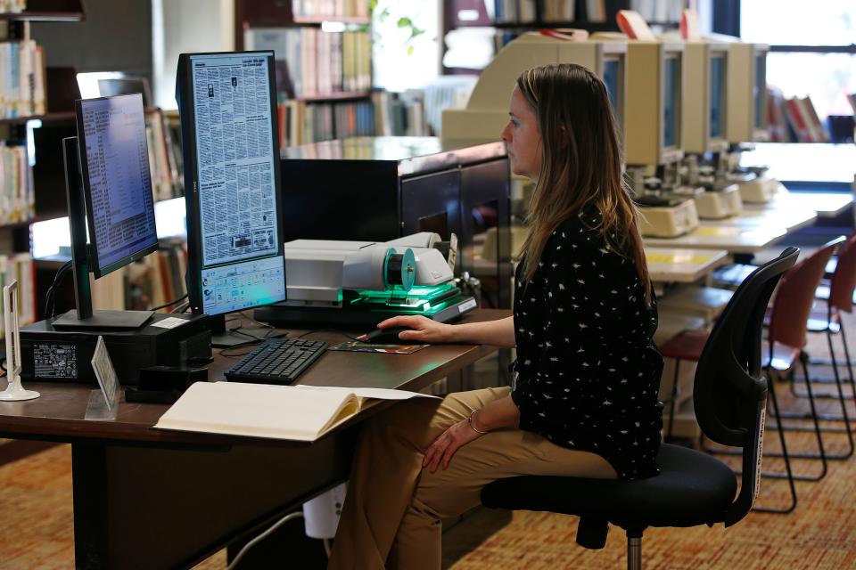 New Bedford public library reference librarian, Amy Ferguson, searches for an online requested Standard-Times obituary using the new microfilm scanner available at the downtown branch.