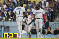 Miami Marlins' Nick Gordon (1) celebrates with Vidal Bruján after hitting a home run during the second inning of a baseball game against the Los Angeles Dodgers in Los Angeles, Monday, May 6, 2024. (AP Photo/Ashley Landis)