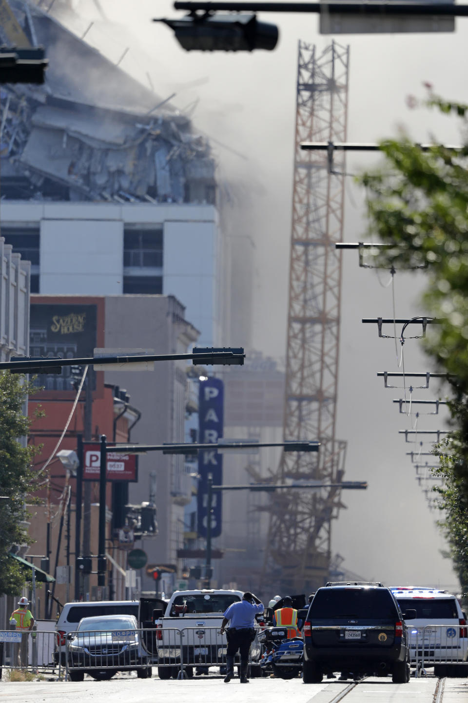 Two large cranes from the Hard Rock Hotel construction collapse come crashing down after being detonated for implosion in New Orleans, Sunday, Oct. 20, 2019. New Orleans officials set off several explosions Sunday intended to topple two cranes that had been looming over the ruins of a partially collapsed hotel. (AP Photo/Gerald Herbert)