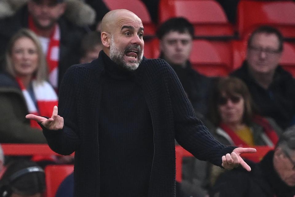 Pep Guardiola gestures on the touchline (AFP via Getty Images)