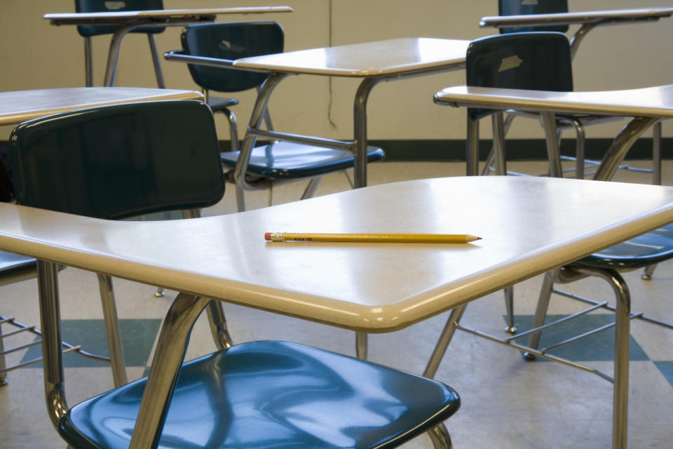 A pencil laying on a school desk