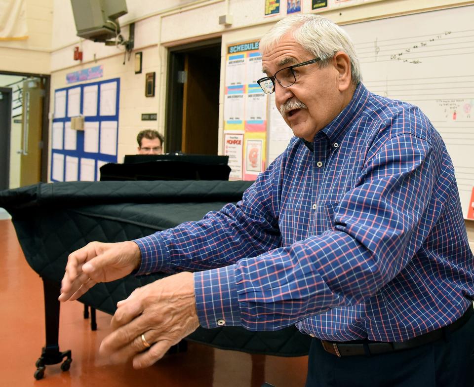 John Tyner, accompanied by Bob Duris, runs through songs with the Monroe High School Concert Choir Wednesday morning. Tyner recently returned to temporarily direct MHS' two choirs after the unexpected death of Cate Windelborn. Concert Choir and Generations of Sound will perform tonight at MHS.