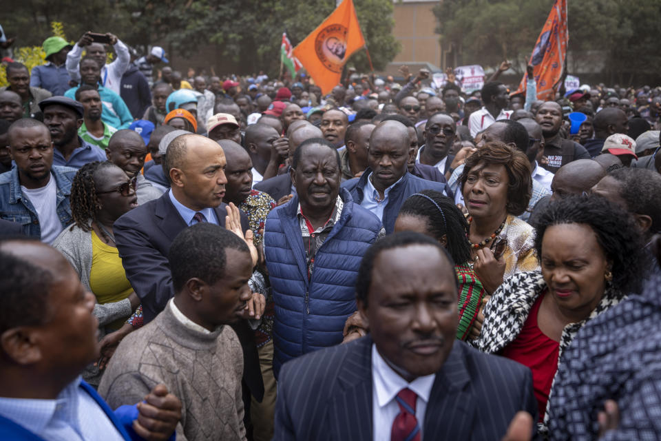 Presidential candidate Raila Odinga, center, arrives amidst crowds of supporters to hand over the petition to the Supreme Court challenging the election results, in Nairobi, Kenya Monday, Aug. 22, 2022. Odinga filed a Supreme Court challenge to last week's election result, asserting that the process was marked by criminal subversion and seeking that the outcome be nullified and a new vote be ordered. (AP Photo/Ben Curtis)