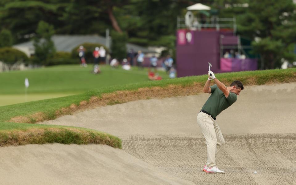 Rory McIlroy of Team Ireland plays a shot from a fairway bunker on the ninth hole - Getty Images