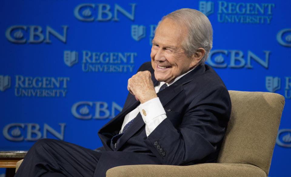 FILE - Rev. Pat Robertson listens as Republican presidential candidate Donald Trump speaks at Regent University in Virginia Beach, Va., Feb. 24, 2016. Robertson, a religious broadcaster who turned a tiny Virginia station into the global Christian Broadcasting Network, tried a run for president and helped make religion central to Republican Party politics in America through his Christian Coalition, has died. He was 93. Robertson's death Thursday, June 8, 2023 was announced by his broadcasting network. (AP Photo/Steve Helber, File)