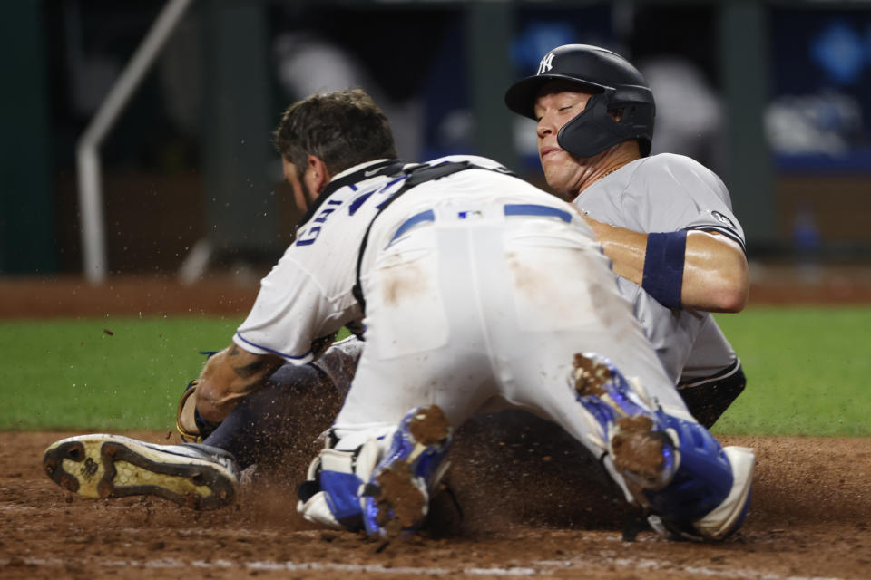 Kansas City Royals catcher Cam Gallagher, left, tags out New York Yankees' Aaron Judge, right, at home plate after Judge attempted to score from third base on a hit in the seventh inning of a baseball game at Kauffman Stadium in Kansas City, Mo., Monday, Aug. 9, 2021. (AP Photo/Colin E. Braley)