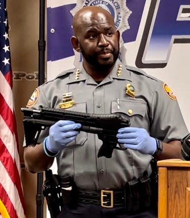 Daytona Beach police Chief Jakari Young holds up a collapsible 9mm Keltec semi-automatic rifle seized from an Embry Riddle Aeronautical University student who police say planned to shoot up the school on Thursday.