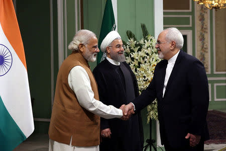 Iran's Foreign Minister Mohammad Javad Zarif (R) shakes hands with India's Prime Minister Narendra Modi as he stands next to Iran's President Hassan Rouhani in Tehran, Iran May 23, 2016. President.ir/Handout via REUTERS