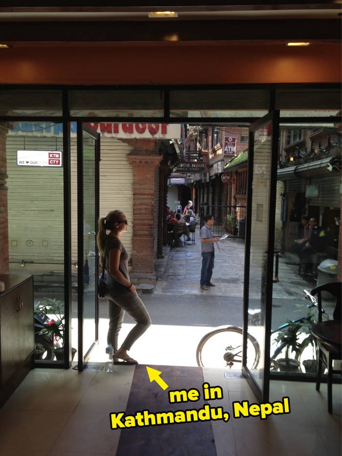 The writer standing at the entrance to a restaurant in Kathmandu, Nepal