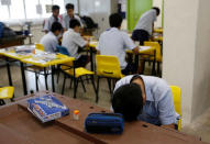 A student takes a break during a model aeroplane assembly enrichment class at a secondary school in Singapore October 27, 2016. Picture taken October 27, 2016. REUTERS/Edgar Su