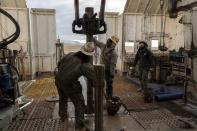 Rig operators connect drills that will plunge underground to access reservoirs of heat, Sunday, Nov. 26, 2023, in Beaver County, Utah. In Nevada, Fervo Energy's first operational project has begun pumping carbon-free electricity onto that state's electric grid to power Google data centers, Google announced Tuesday, Nov. 28. Fervo is using the Nevada pilot to launch larger projects like this one in Utah to deliver far more carbon-free electricity to the grid. (AP Photo/Ellen Schmidt)