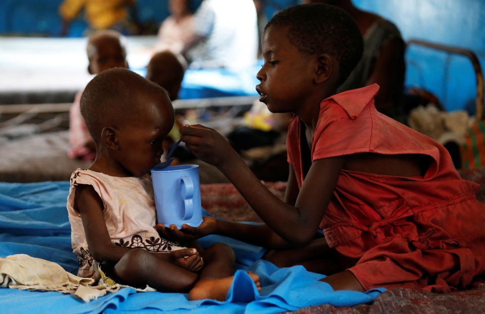 <p>An internally displaced child feeds her severely acute malnourished sibling as they wait to receive medical attention at the Tshiamala general referral hospital of Mwene Ditu in Kasai Oriental Province in the Democratic Republic of Congo, March 15, 2018. (Photo: Thomas Mukoya/Reuters) </p>