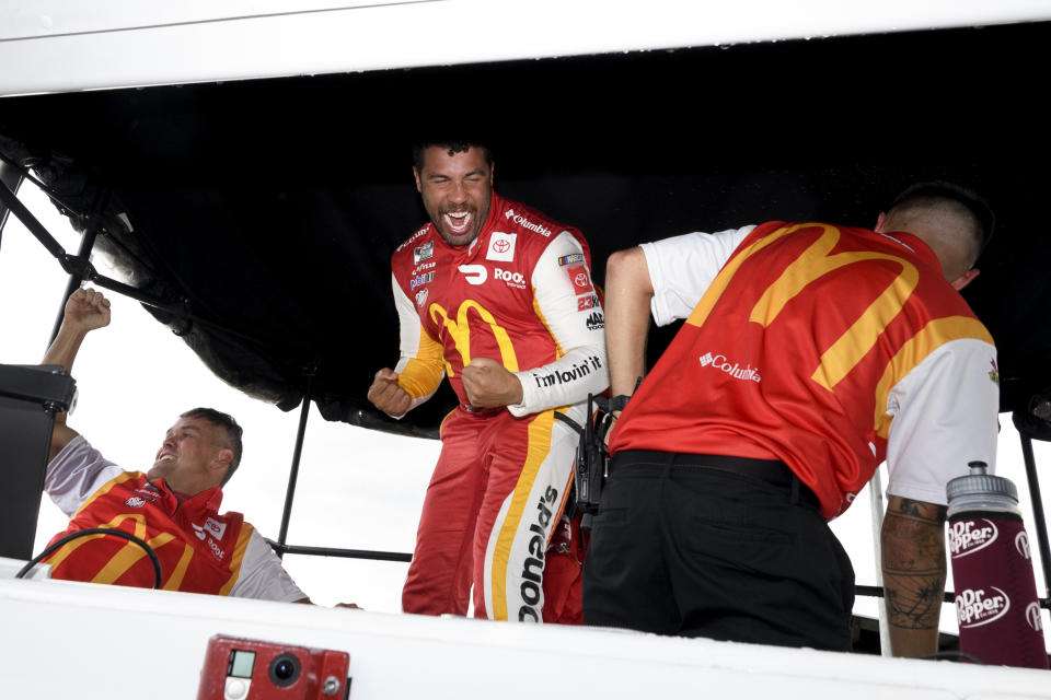 Bubba Wallace, center, and crew react after he is pronounced the winner of a NASCAR Cup series auto race which was stopped for a rain delay, Monday, Oct. 4, 2021, in Talladega, Ala. (AP Photo/John Amis)