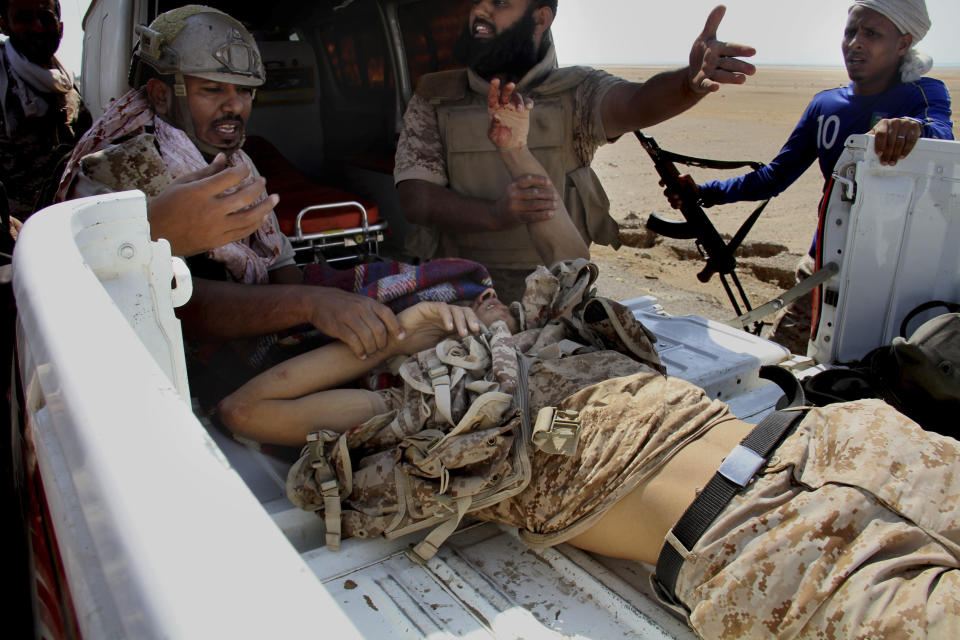 Coalition-backed fighters help a wounded man during an advance on Yemen’s Red Sea port town of Mocha in this Jan. 11 2017, photo. Some of the fighters in the unit openly al-Qaida, wearing Afghan-style garb and carrying weapons with an al-Qaida logo, a sign of how closely the militant group is involved in the fight against Shiite rebels known as Houthis. The coalition fighters eventually succeeded in taking Mocha from the Houthis. (AP Photo)