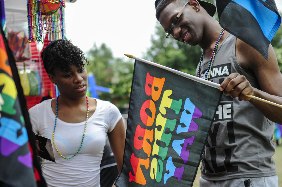 Participants look at a Born This Way sign as they browse a booth selling Pride items during the Pride Festival at the Augusta Commons on June 28, 2014, in Augusta, Ga. (Sara Caldwell / The Augusta Chronicle via AP file)