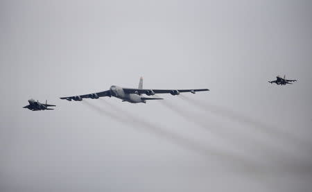 A U.S. Air Force B-52 (C) flies over Osan Air Base in Pyeongtaek, South Korea, January 10, 2016. REUTERS/Kim Hong-Ji