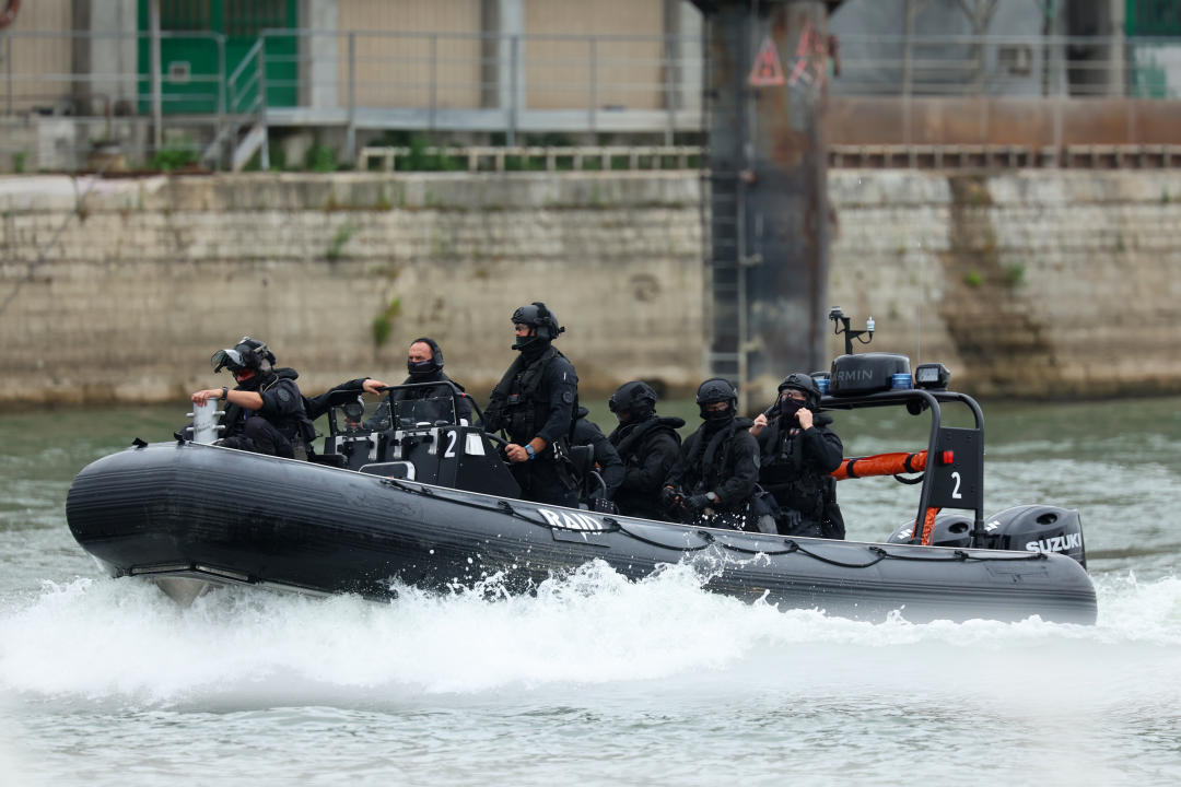 PARIS, FRANCE - JULY 26:  Security officers on boats navigate along the River Seine prior to the opening ceremony of the Olympic Games Paris 2024 on July 26, 2024 in Paris, France. (Photo by Michael Reaves/Getty Images)