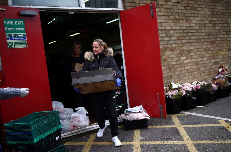 Dionne Tracey carries a crate of food items to be delivered to local residents from the Docklands Settlements Community Centre in Stratford, as the spread of the coronavirus disease (COVID-19) continues, in east London