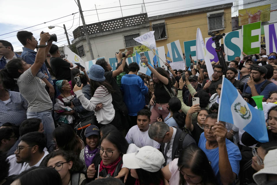 Demonstrators protest in front of Guatemala's Attorney General's office building in Guatemala City, Thursday, July 13, 2023. The Constitutional Court, which is the country's highest tribunal, has granted a preliminary injunction to the Seed Movement, blocking its suspension from the runoff presidential election. (AP Photo/Moises Castillo)