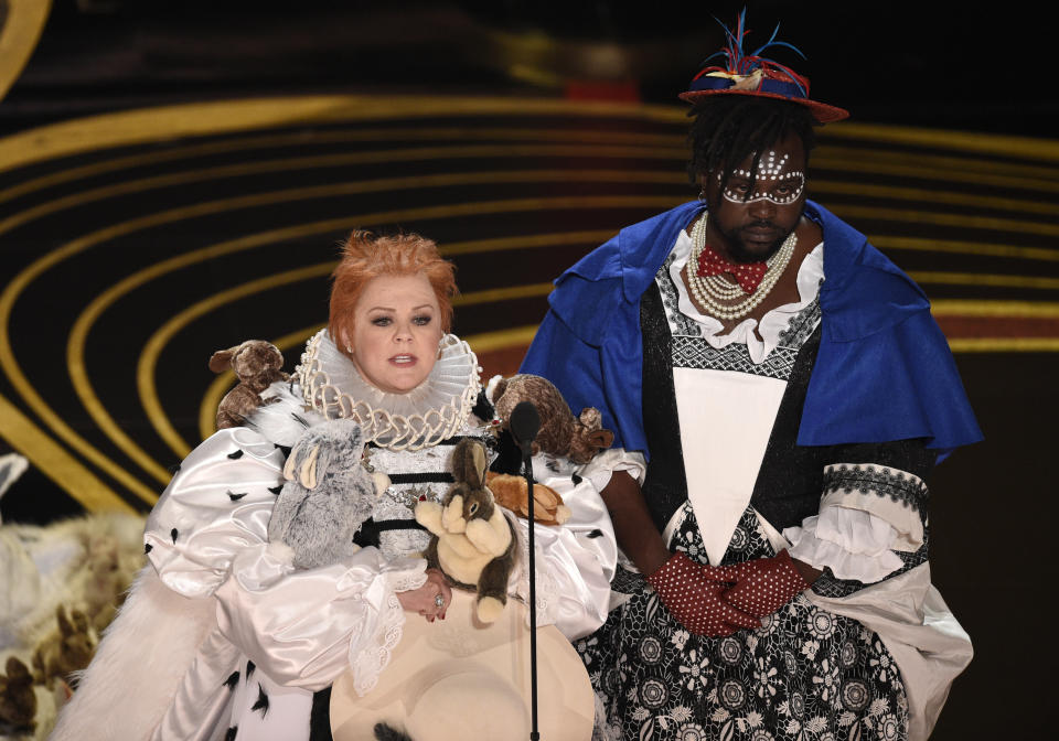 Melissa McCarthy and Brian Tyree Henry present the award for Best Costume Design at the Oscars. (Photo by Chris Pizzello/Invision/AP)