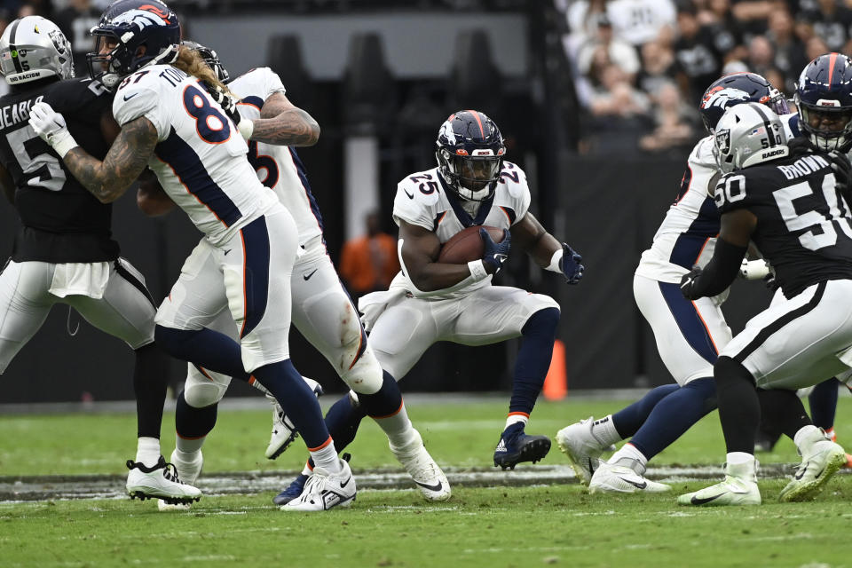 Denver Broncos running back Melvin Gordon III (25) runs the ball against the Las Vegas Raiders during the first half of an NFL football game, Sunday, Oct. 2, 2022, in Las Vegas. (AP Photo/David Becker)