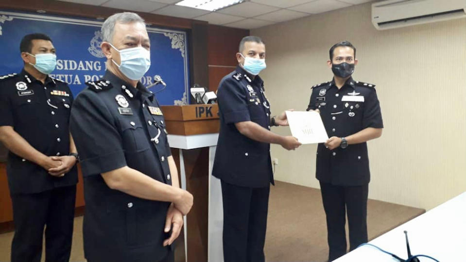 Johor police chief Datuk Ayob Khan Mydin Pitchay (centre) after giving out integrity commendation letters to police officers at the Johor police contingent headquarters in Johor Baru December 3, 2020. — Picture by Ben Tan