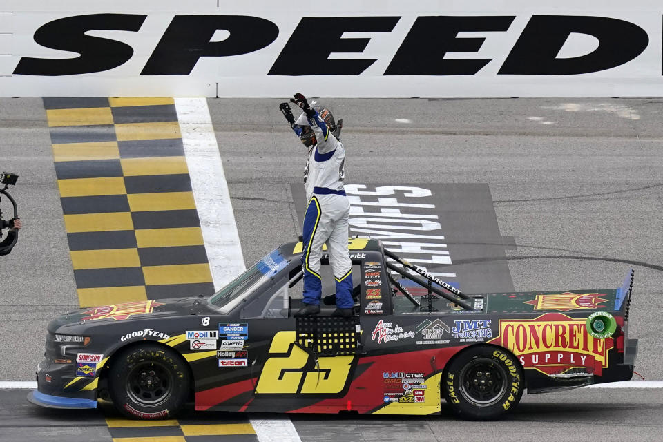 Brett Moffitt (23) celebrates after winning a NASCAR Truck Series auto race at Kansas Speedway in Kansas City, Kan., Saturday, Oct. 17, 2020. (AP Photo/Orlin Wagner)