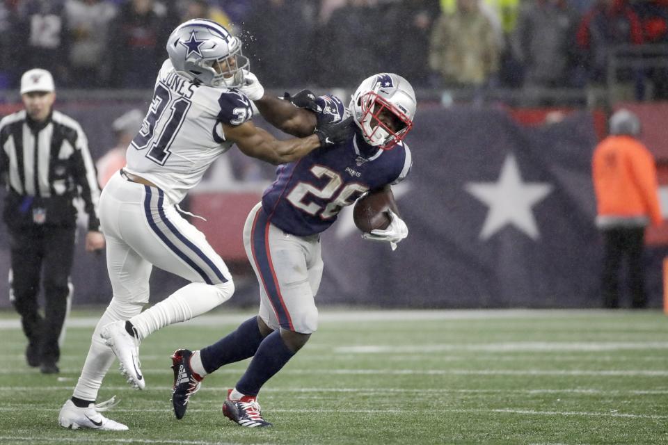 New England Patriots running back Sony Michel, right, gives a stiff arm to Dallas Cowboys cornerback Byron Jones. (AP Photo/Elise Amendola)