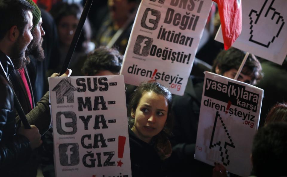 Protesters shout slogans, hold banners and wave flags as they demonstrate against new controls on the Internet approved by Turkish parliament this week in Ankara