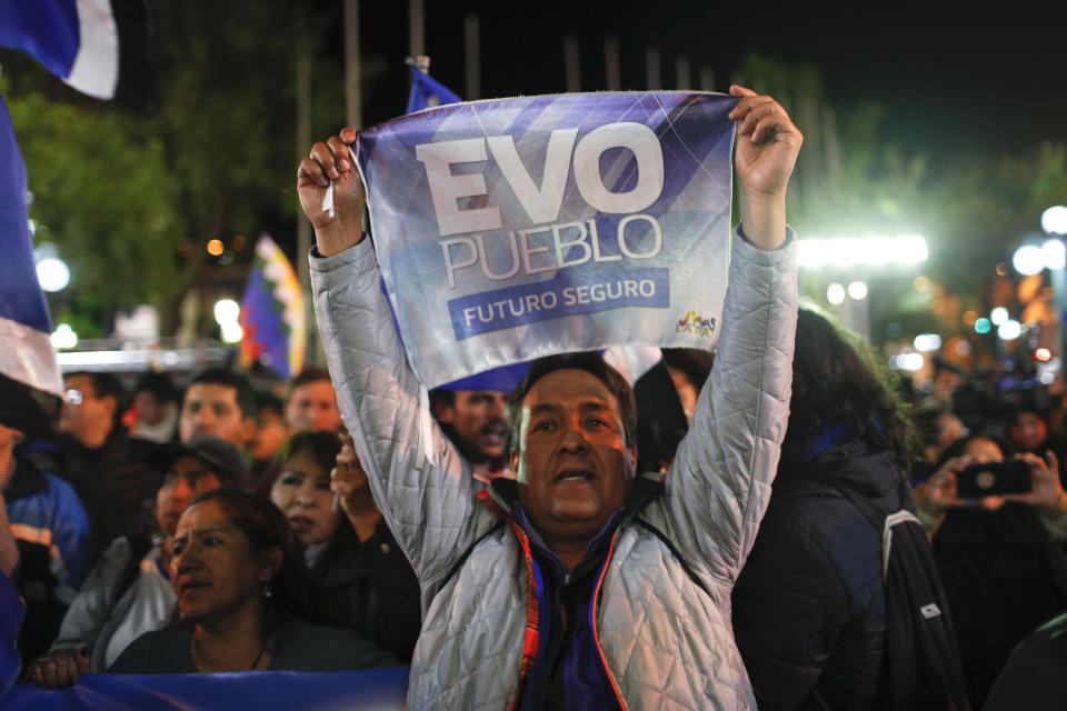 A supporter of Bolivian President Evo Morales shows his support outside the presidential palace in La Paz, Bolivia, after a first round presidential election, Sunday, Oct. 20, 2019. According to official early returns, Morales is in the lead but appears headed to a December runoff against former President Carlos Mesa. (AP Photo/Juan Karita)
